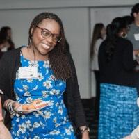 GVSU Alumni smiling during conversation with each other